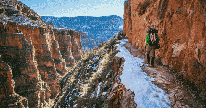 backpacker overlooking a canyon while backpacking and hiking what to bring on a multi day trip epic trails