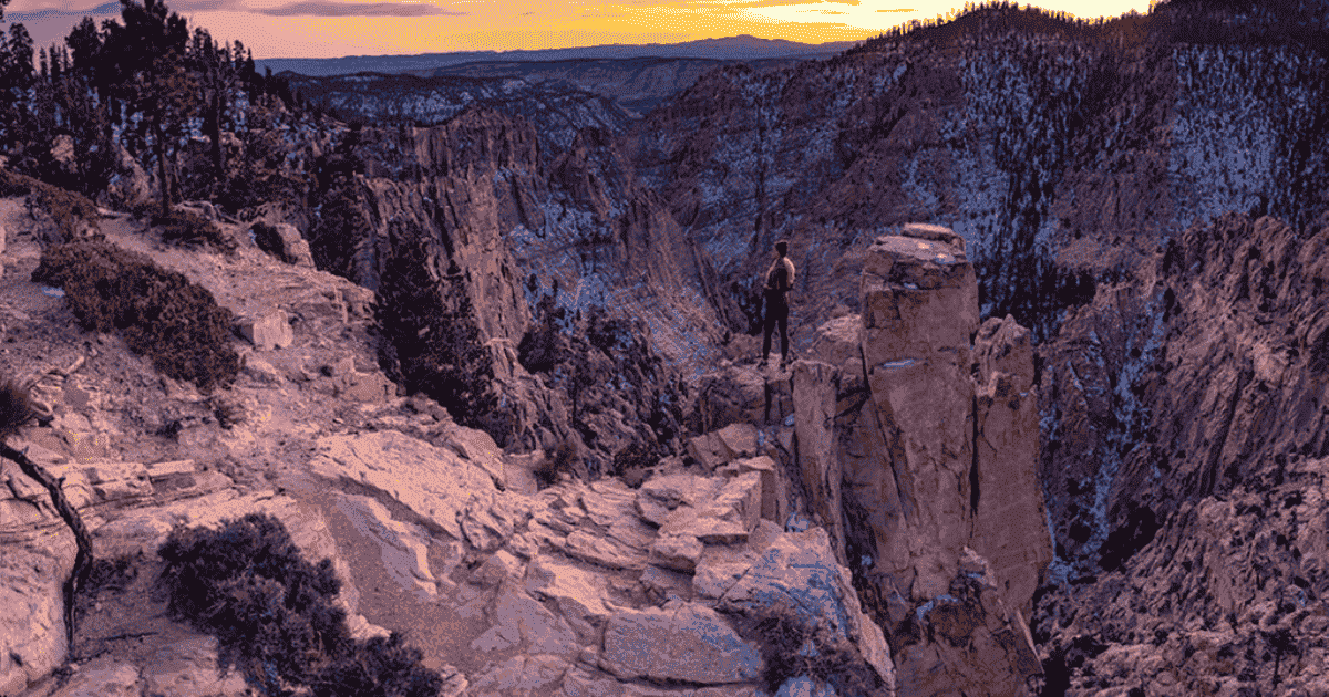 kristi overlooking the landscape with the sun setting backpacking and hiking
