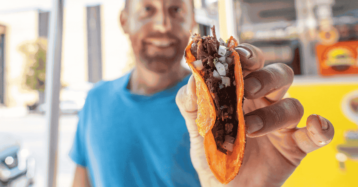 eric holding a taco at a food truck in san francisco backpacking and hiking