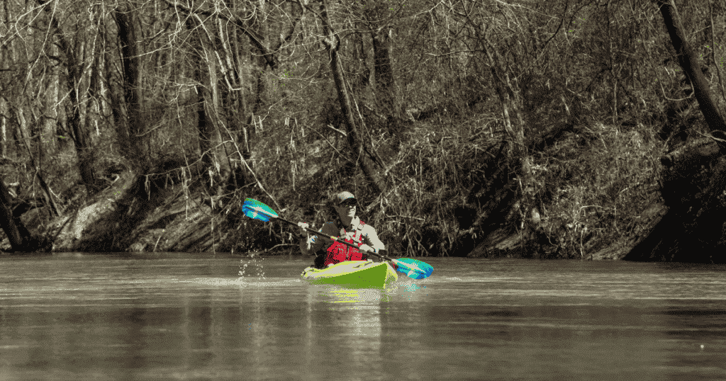 ken whiting paddling in a forest using the liquid logic saluda kayak