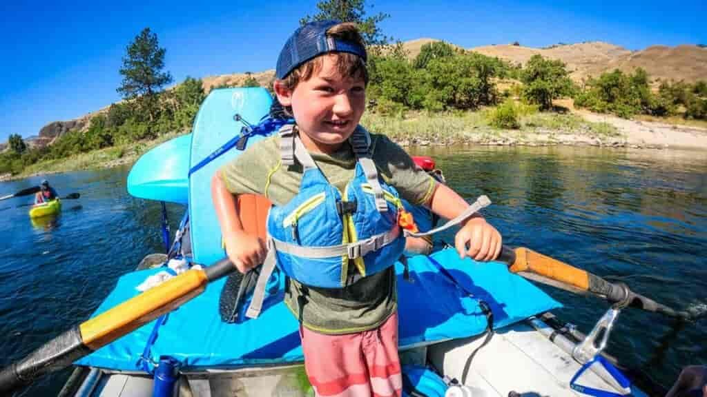 best family adventure vacations: Everyone gets a chance to be the raft guide on our trips!